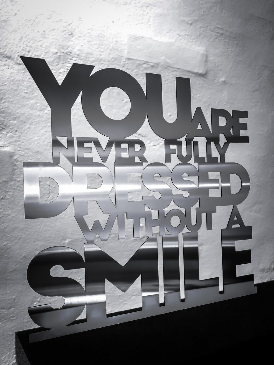 You are never fully dressed without a smile - Stainless steel 33.5x32cm