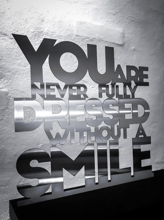 You are never fully dressed without a smile - Stainless steel 33.5x32cm